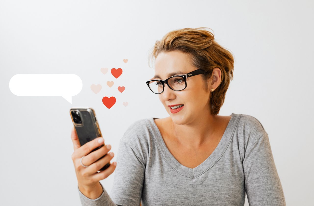 hero-img-01 Adult woman wearing eyeglasses and using phone, surrounded by digital love heart symbols on a white background.